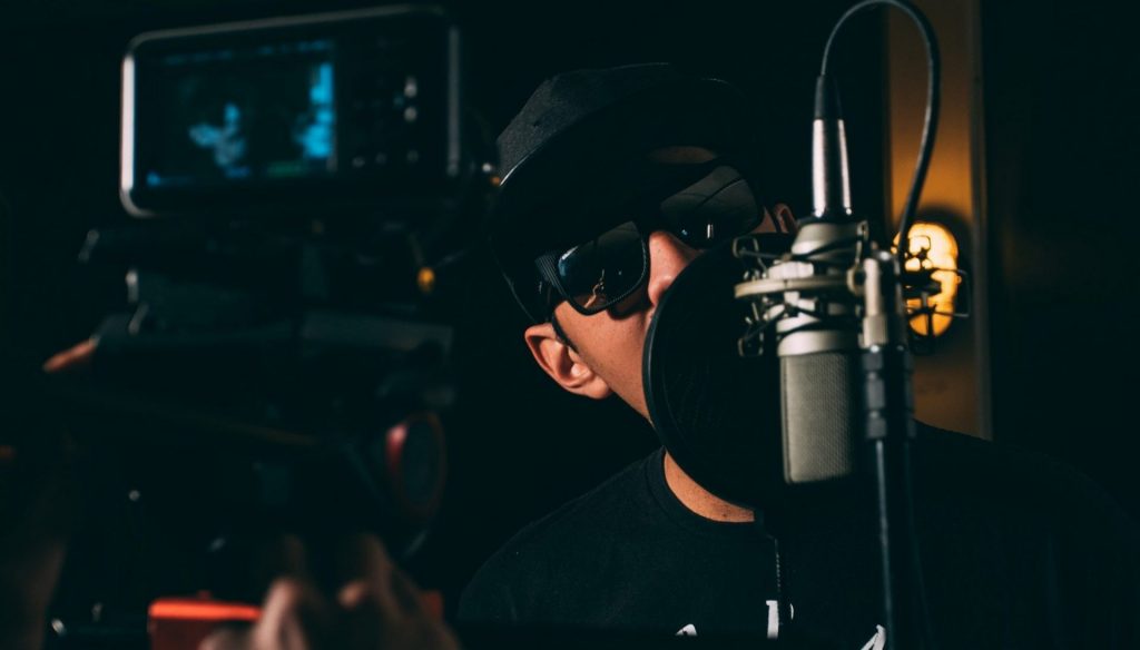 image of a rapper recording a song