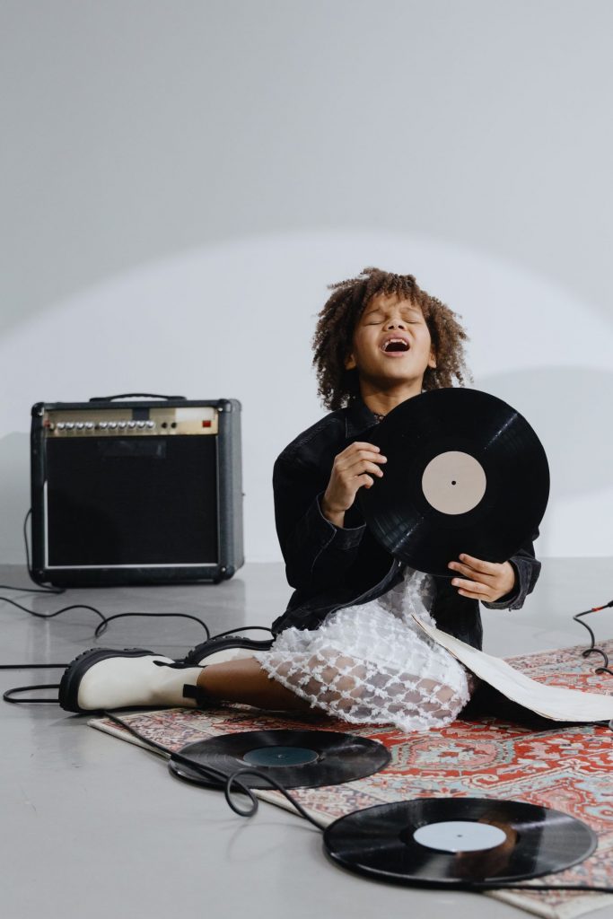 Picture of a girl singing in the air trying to find voice melodies for a song